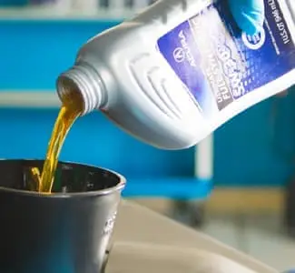 Oil being poured into funnel