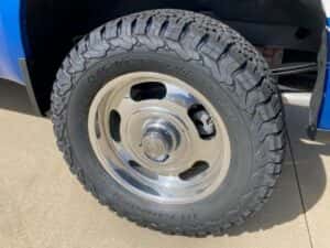 Custom chevy pickup truck blue with white side panel driver side rear tire.jpeg
