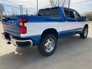 Custom chevy pickup truck blue with white side panel passenger rear angle
