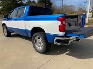 Custom chevy pickup truck blue with white side panel tailgate open