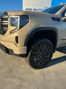 tan custom gmc pickup truck front tire view