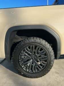 tan custom gmc pickup truck passenger rear tire view