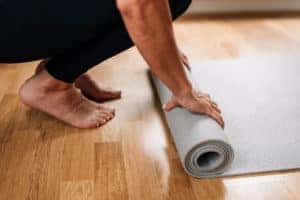 woman rolling out yoga mat