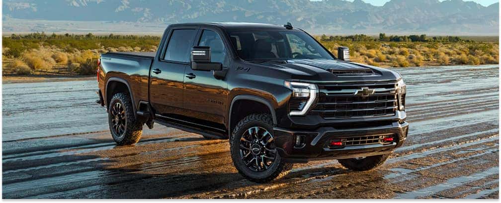 Front three-quarter view of a black 2026 Chevrolet Silverado HD ZR2 on an off-road trail.