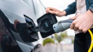 Electric vehicle plugged in and charging at a public charging station near Omaha, NE.