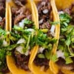Close up of a row of tasty looking tacos
