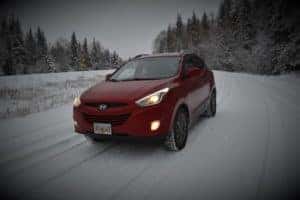 Red Hyundai driving in winter