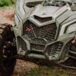A front view of a dirty ATV vehicle off-roading