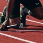Man at starting position on running track