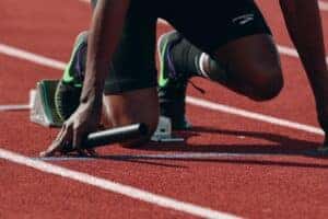Man at starting position on running track