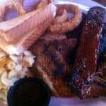 A plate of bbq, including mac and cheese and bread