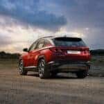 2023 Red Hyundai Tucson on a dirt road at sunset in Alabama