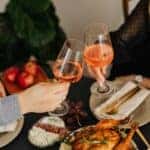 Man and Woman drinking wine while being served dinner