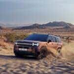 2024 Hyundai Santa Fe racing through the sand.