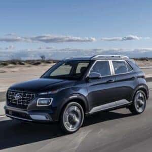 2024 Hyundai Venue driving through an arid area.
