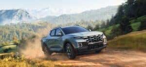 2024 Hyundai Santa Cruz in silver on a dirt road in Alabama.