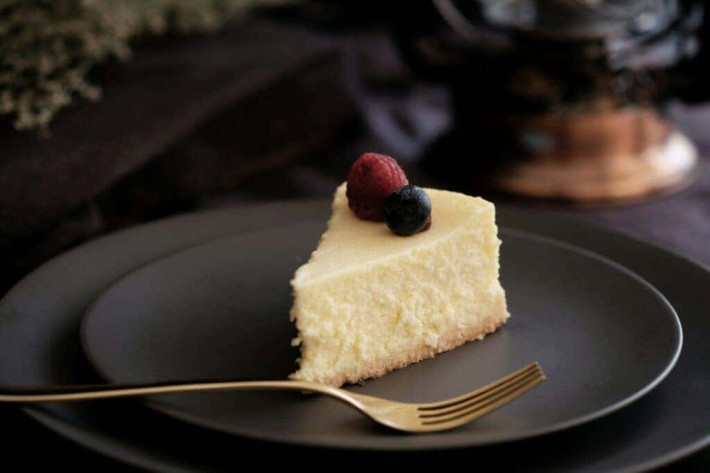 A delicious slice of cheesecake with berries on top at a shop in Montgomery, AL