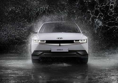 Grayscale Photo of a Hyundai Ioniq 5 in the Rain