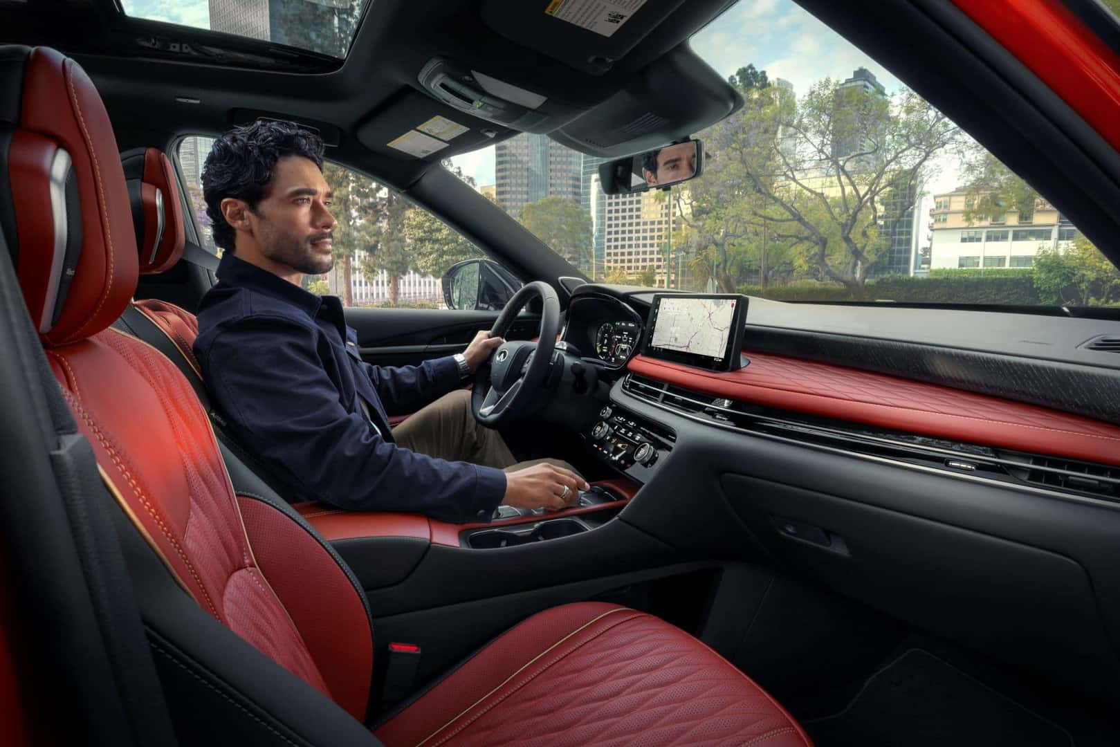 Driver enjoying personalized audio technology in an INFINITI luxury SUV