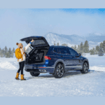 Women opening back or Tiguan in snow