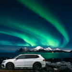 White Volkswagen Atlas under the Northern Lights