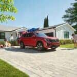 Red 2024 Volkswagen Atlas in a family's driveway