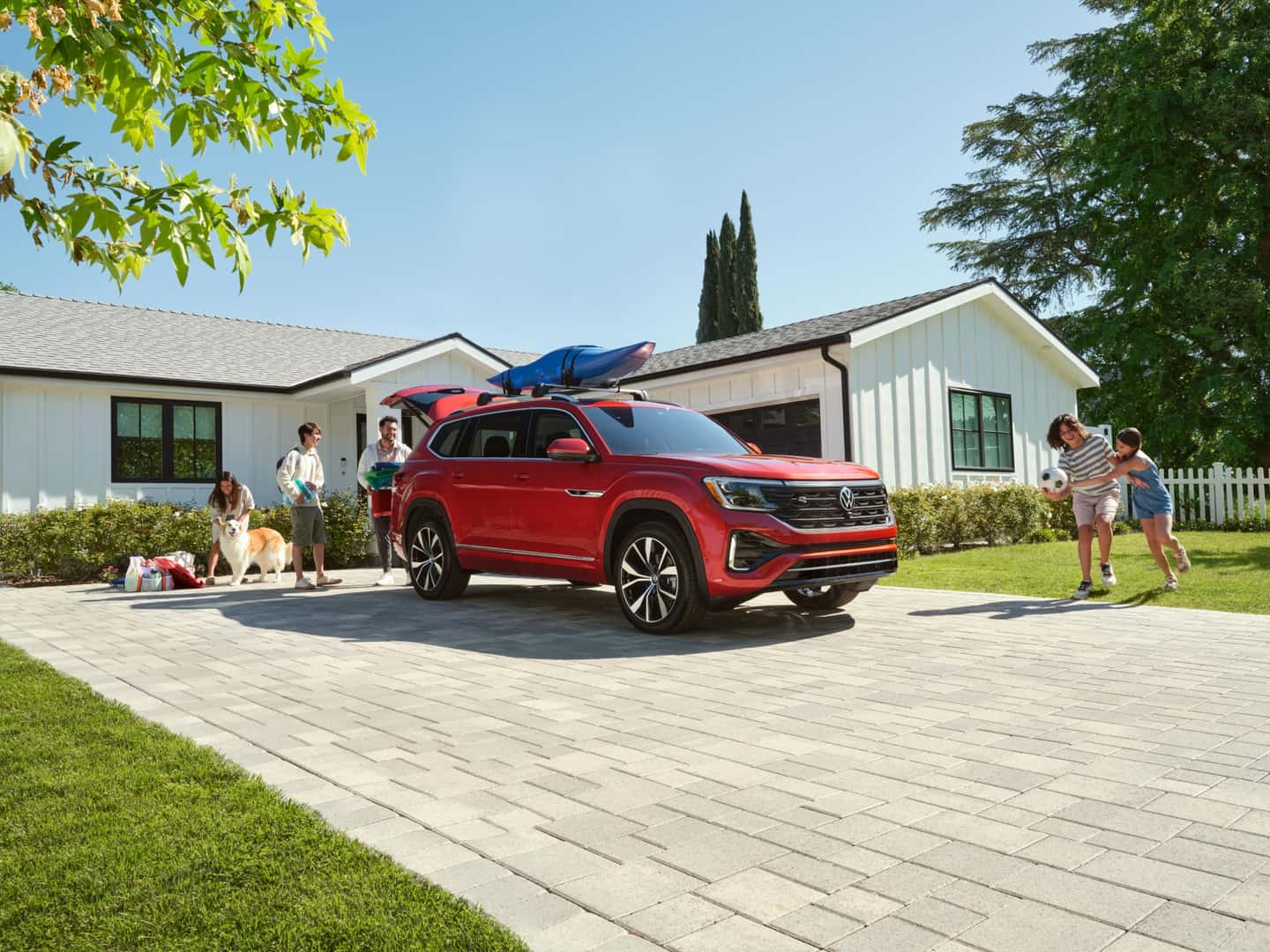 Red 2024 Volkswagen Atlas in a family's driveway