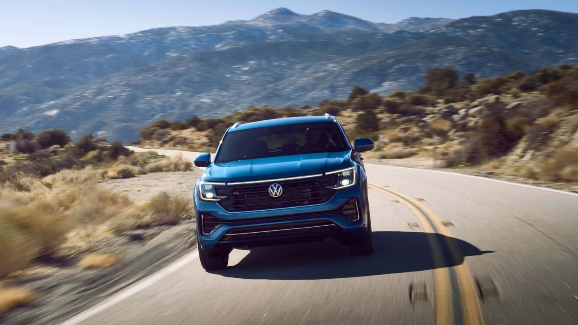 2025 Volkswagen Atlas Cross Sport driving through a mountain over pass