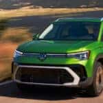 2026 Volkswagen Taos driving down the road