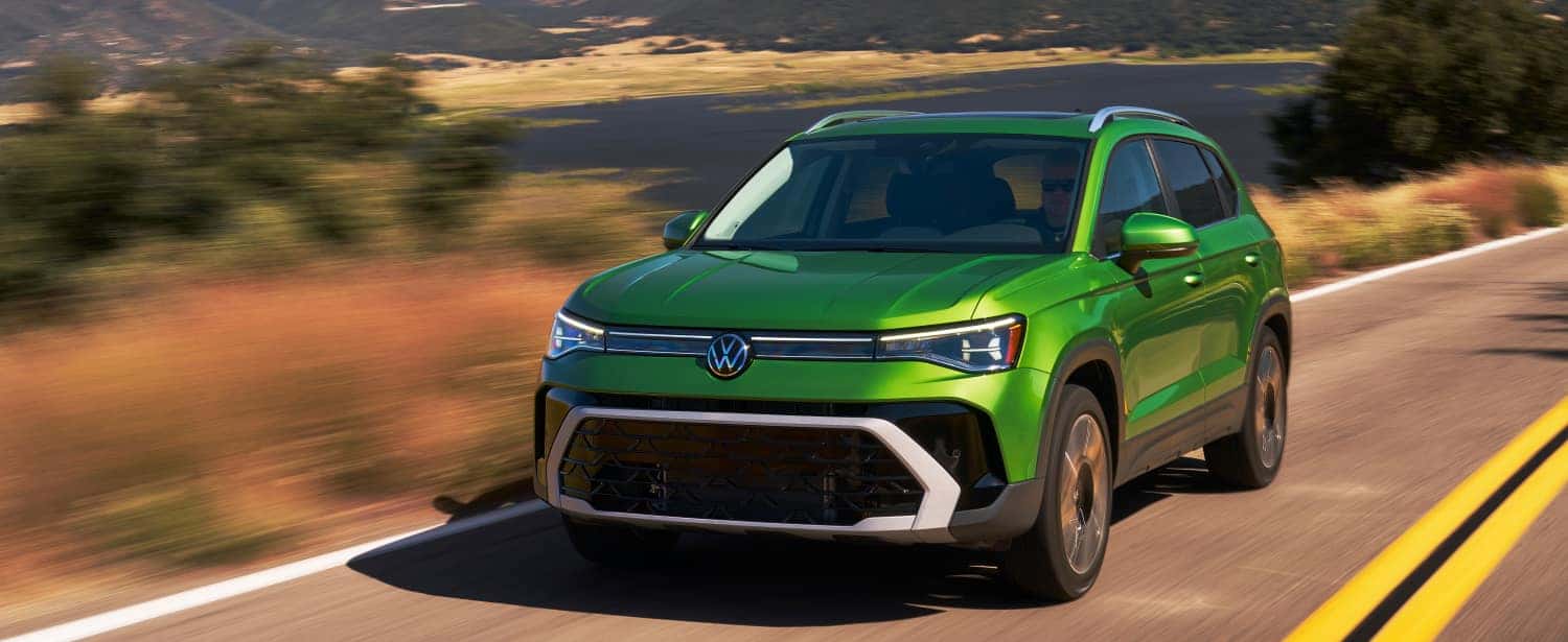2026 Volkswagen Taos driving down the road