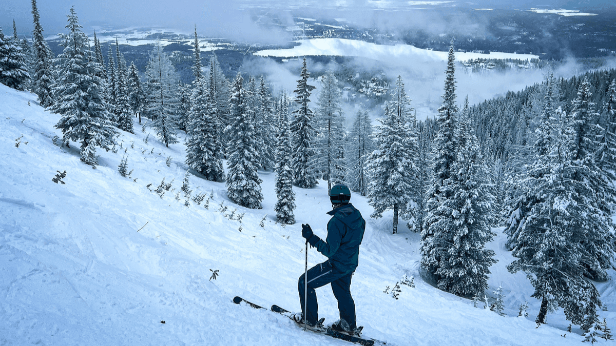 Skier looking down a slope on Whitefish Mountain Resort in Whitefish Montana