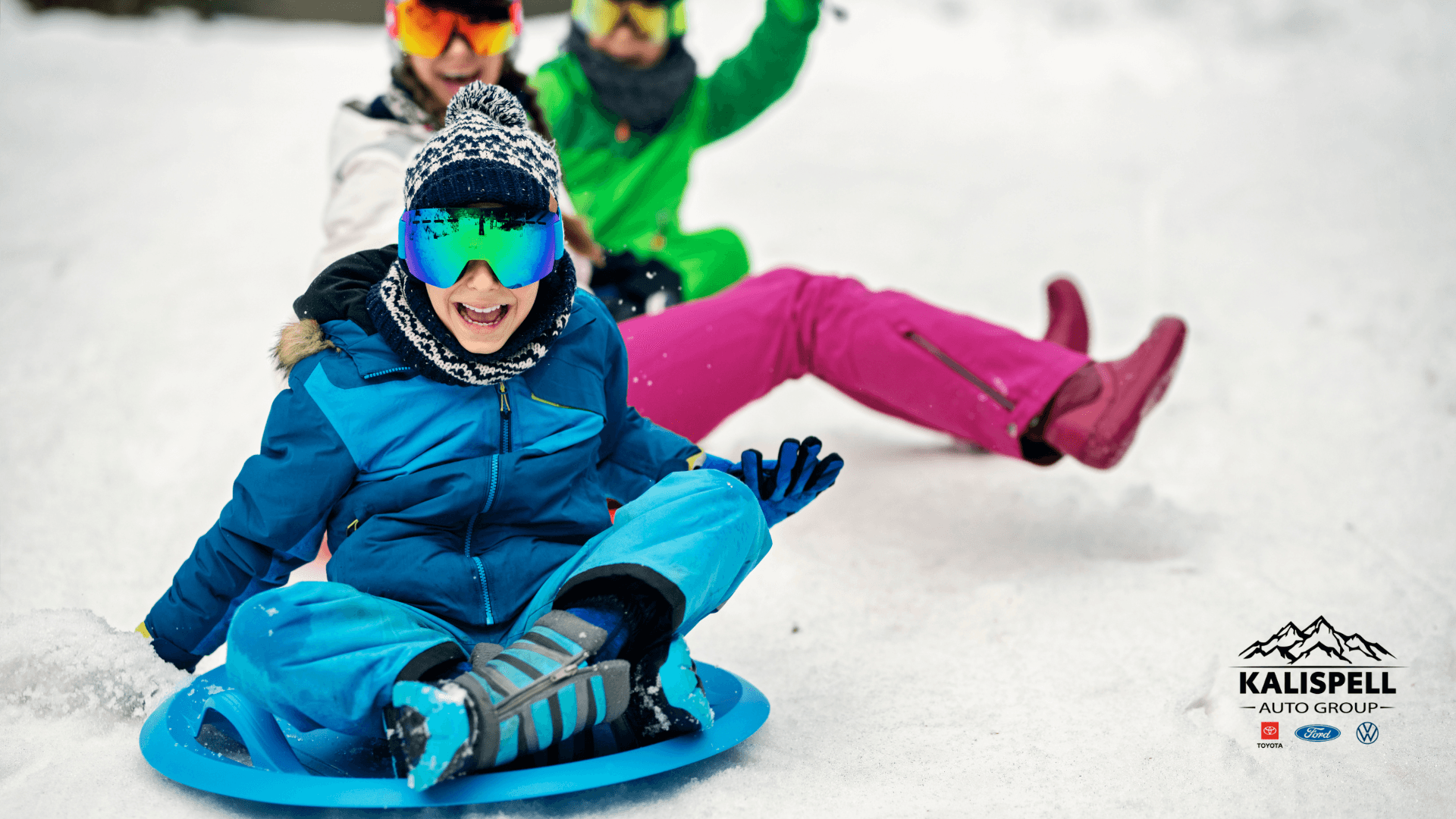 Stock image of people sledding in the winter snow