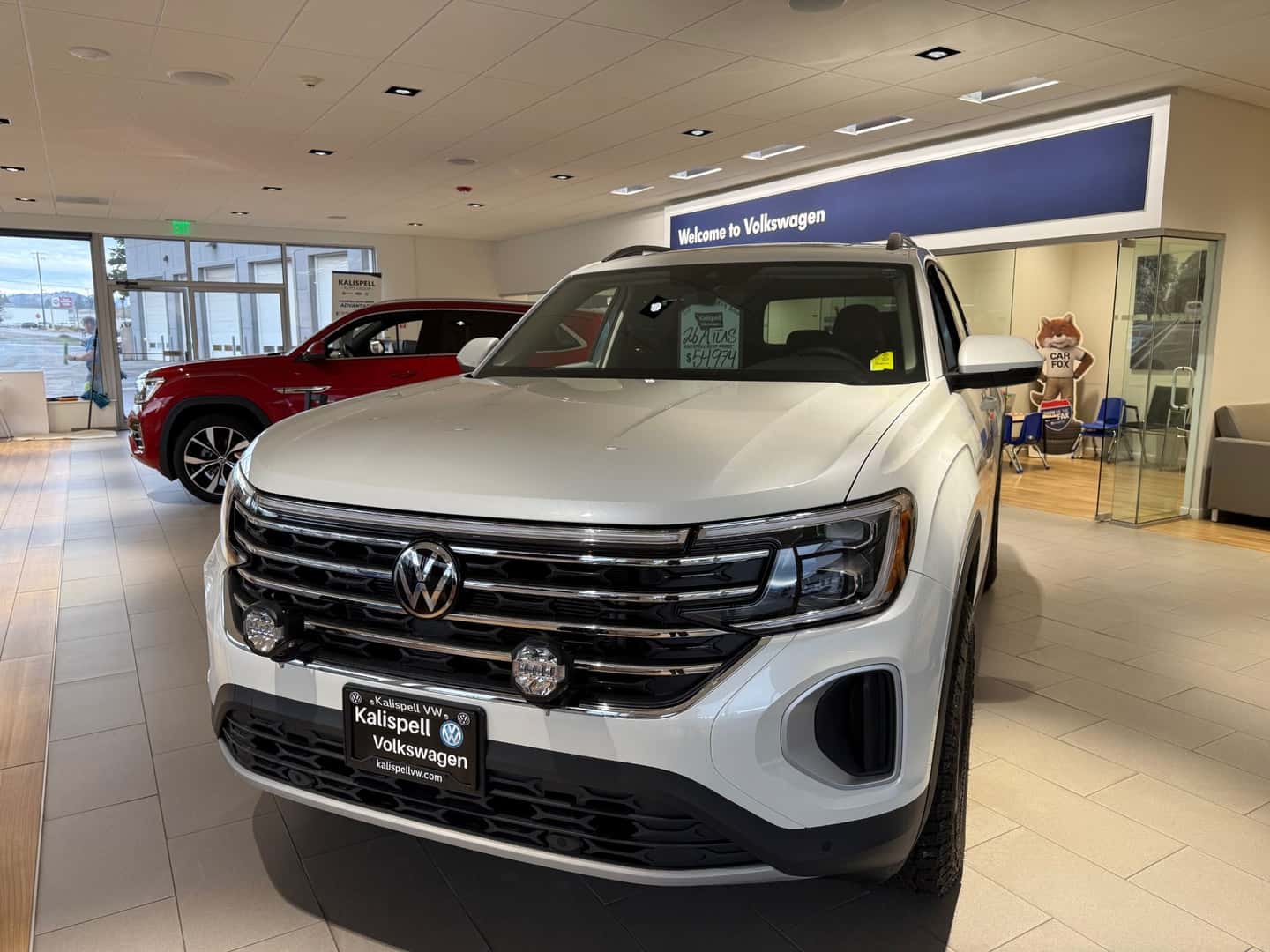 White 2026 Volkswagen Atlas sitting the Kalispell Volkswagen showroom in Northwest Montana