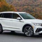A white Used Volkswagen Tiguan with a forest in the background