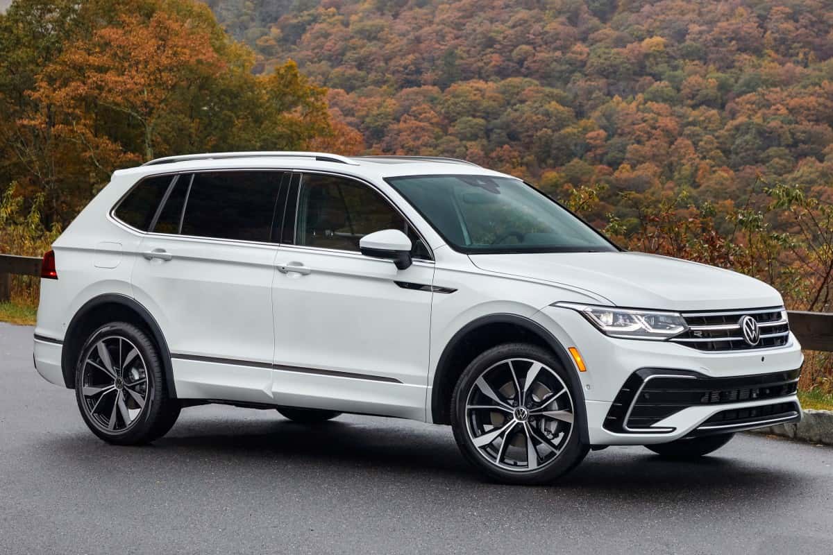 A white Used Volkswagen Tiguan with a forest in the background