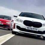 Volkswagen and BMW driving on a road side by side