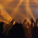 People raising hands on concert