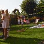 A family enjoys backyard games and a Labor Day cookout