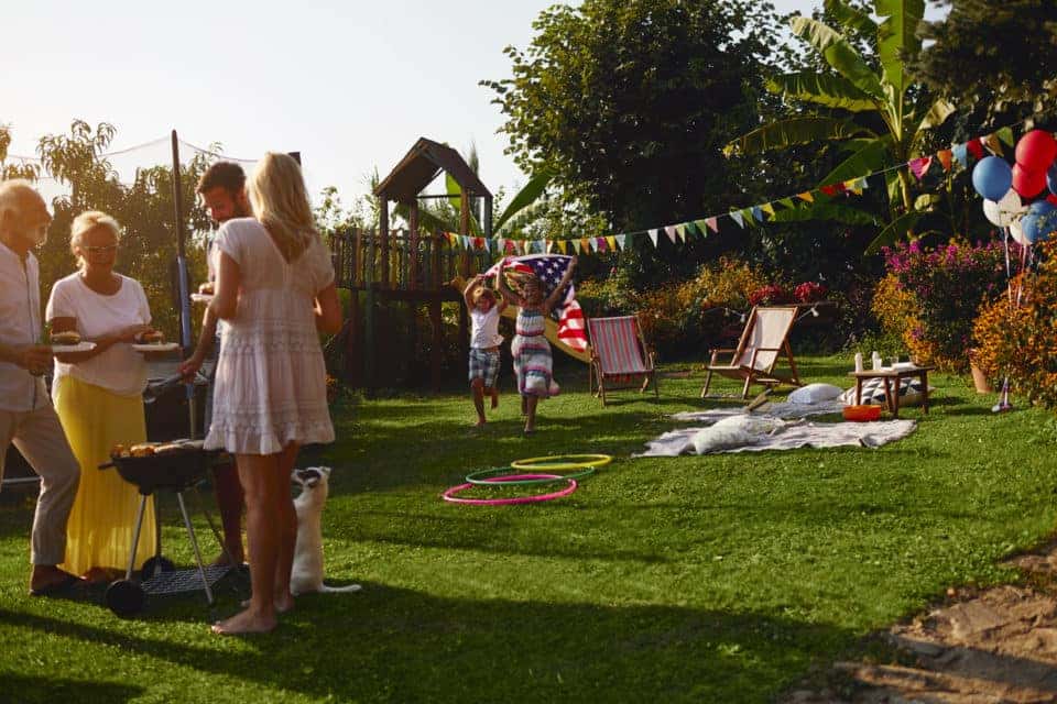 A family enjoys backyard games and a Labor Day cookout