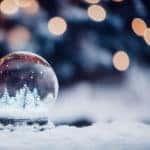 Closeup shot of a beautiful snow globe on the background of bokeh lights