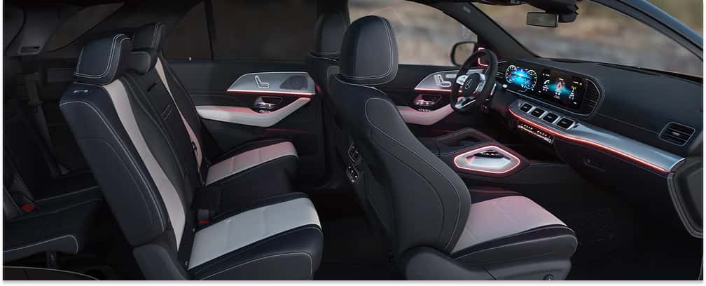 2026 Mercedes-Benz GLE SUV interior featuring two-tone leather seating, digital dashboard displays, and ambient lighting.