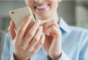 Woman typing on mobile phone