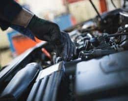 Service technician's hand working on engine