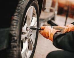 Service technician working on vehicle tires