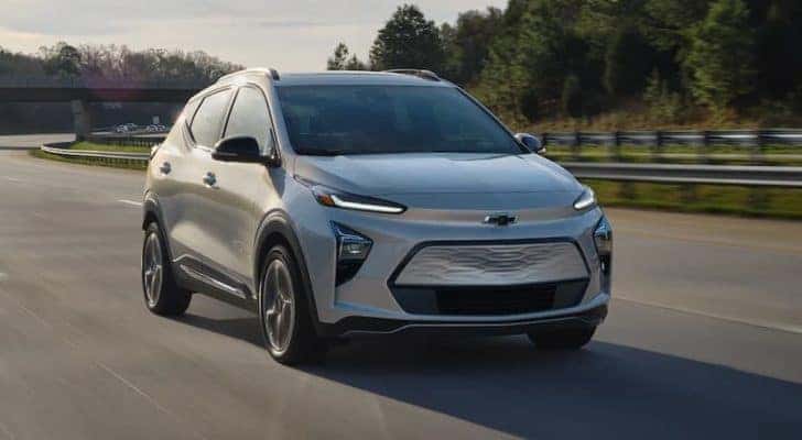 A silver 2022 Chevy Bolt EVU driving on a highway after leaving a Russellville Chevy dealer.