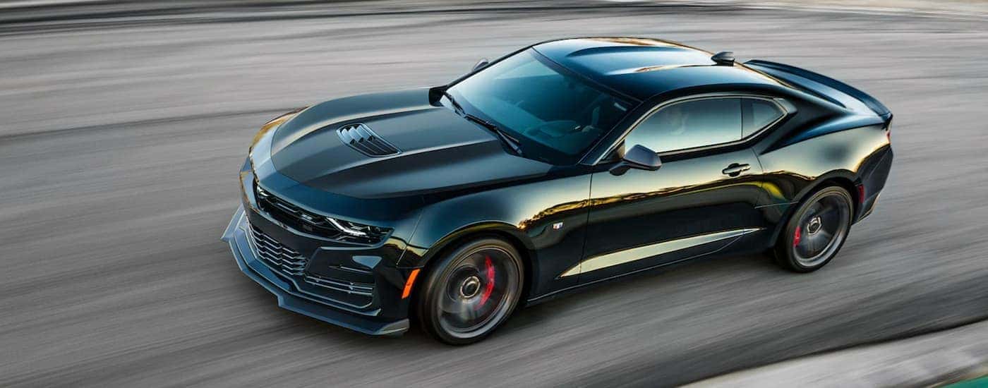 Overhead view of a black 2022 Chevy Camaro driving on a racetrack.
