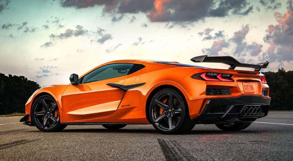 Pavement-level view of an orange 2023 Chevy Corvette Z06 parked at an angle in the road