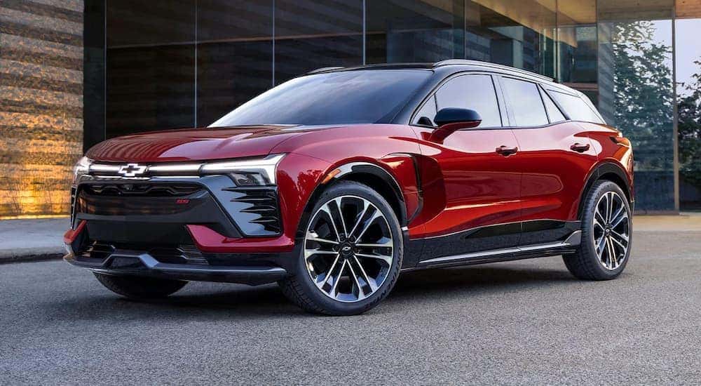A red 2024 Chevy Blazer SS EV parked in a modern driveway.
