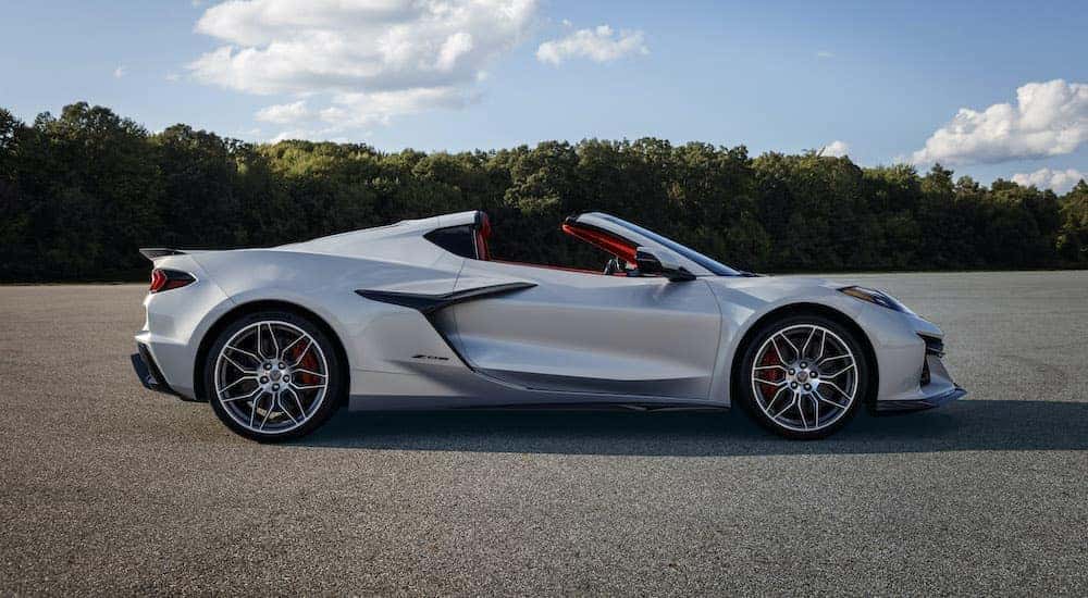 A silver 2023 Chevy Corvette Z06 is shown from the side while parked.