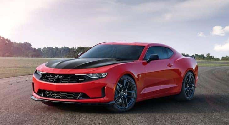 A red 2020 Chevy Camaro SS parked on a racetrack on a sunny day.